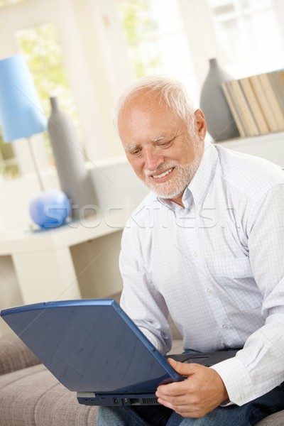 623493_stock-photo-smiling-elderly-man-looking-at-computer-screen.jpg